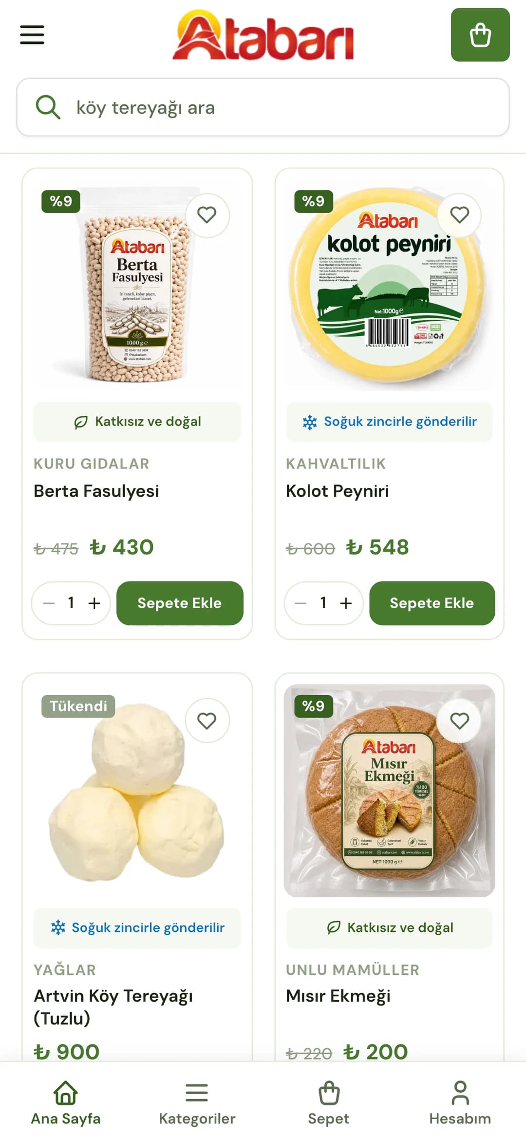 Atabarı ana sayfasındaki En Çok Tercih Edilenler kartları telefonda: %9 indirimli Berta fasulyesi (Katkısız ve doğal etiketi, ₺ 475 yerine ₺ 430), %9 indirimli kolot peyniri (mavi Soğuk zincirle gönderilir etiketi, ₺ 600 yerine ₺ 548), Tükendi rozetli Artvin köy tereyağı (Soğuk zincirle gönderilir) ve %9 indirimli mısır ekmeği; kartlarda kategori adı, adet seçici ve Sepete Ekle düğmesi.