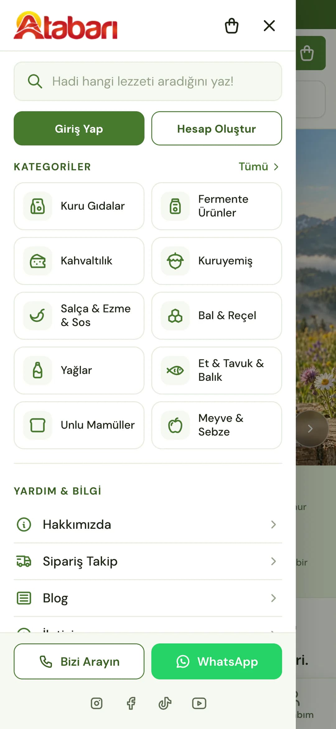 Atabarı'nın telefonda açılan menüsü: logo, sepet ve kapat simgeleri, Hadi hangi lezzeti aradığını yaz! arama kutusu, Giriş Yap ve Hesap Oluştur düğmeleri; Kategoriler altında ikonlu kutularla Kuru Gıdalar, Fermente Ürünler, Kahvaltılık, Kuruyemiş, Salça & Ezme & Sos, Bal & Reçel, Yağlar, Et & Tavuk & Balık, Unlu Mamüller ve Meyve & Sebze; Yardım & Bilgi altında Hakkımızda, Sipariş Takip ve Blog; altta Bizi Arayın ve WhatsApp düğmeleri.