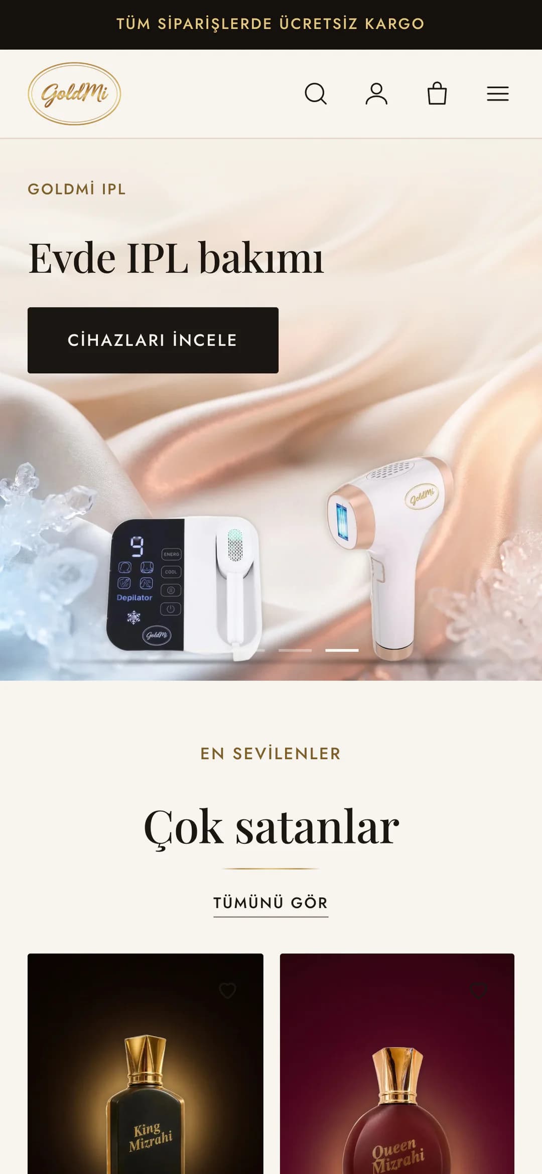 Goldmi ana sayfasının IPL açılış slaytı telefonda: GoldMi IPL etiketi, Evde IPL bakımı başlığı ve siyah Cihazları incele düğmesi; açık saten ve buz parçaları önünde dokunmatik ekranlı HRM1 ile beyaz IPL-01 epilasyon cihazları.
